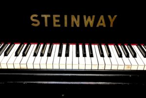 A picture of steinway piano with large fonts logo